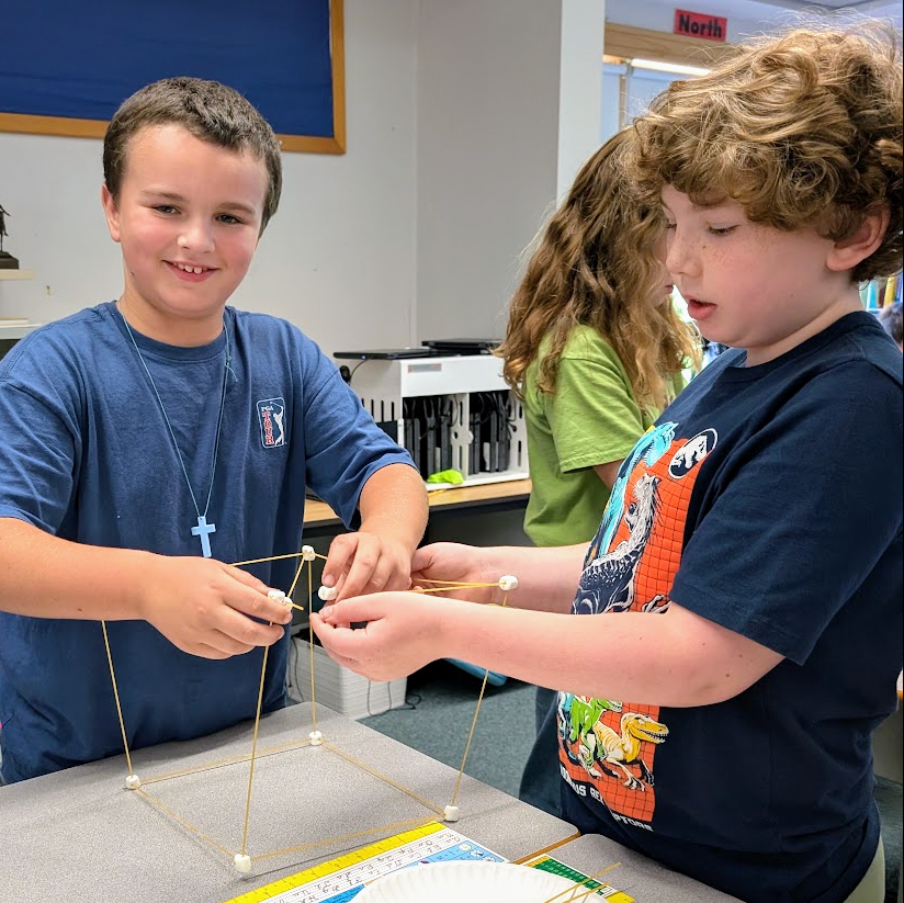 Students work together to build the tallest tower of spaghetti and marshmallows possible.